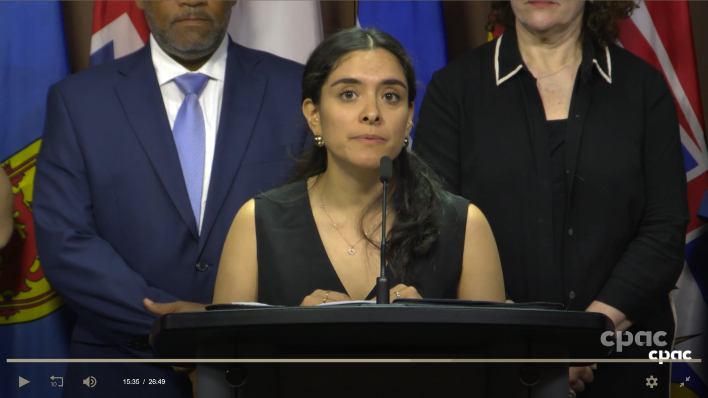 Photo of Action Canada staff delivering statement at a news conference.