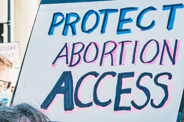 A sign that says "PROTECT ABORTION ACCESS"
