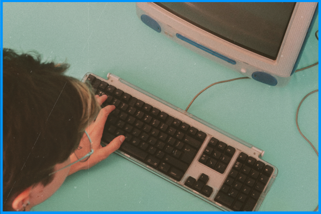 Person using a computer and keyboard from the 2000s