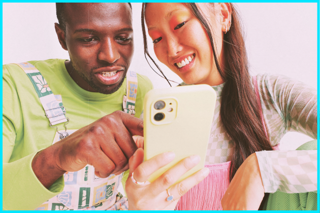 Two people looking at a smartphone