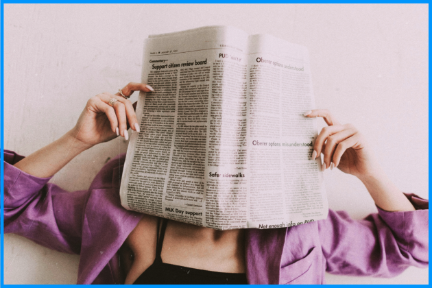 Person with a newspaper over their face.