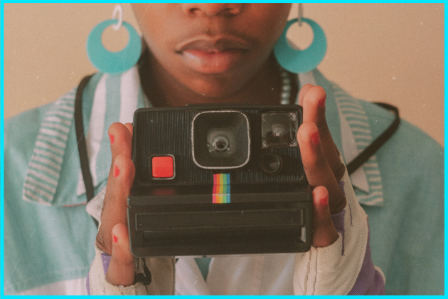 Person using polaroid camera