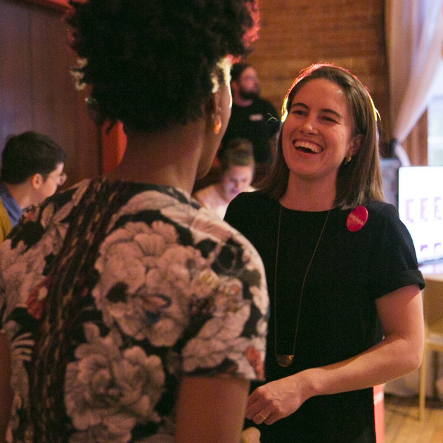 Makeda laughing with a colleague