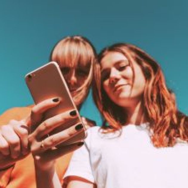 Two women using a phone
